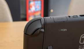 Close-up view of the right Joy-Con seen from behind, showing the shoulder buttons and the release button