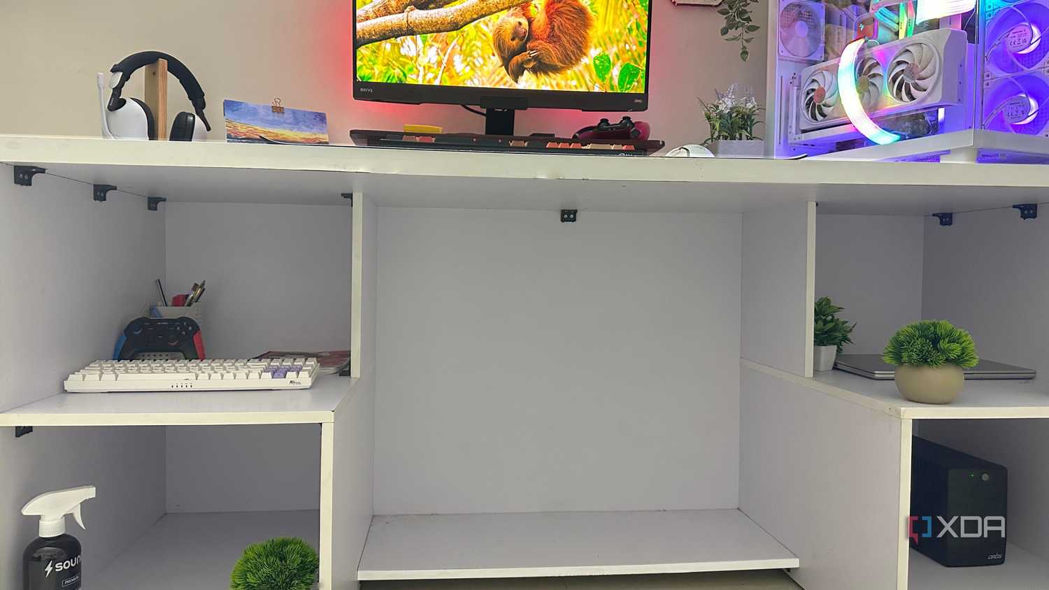 An image of a white computer table with sectioned compartments.