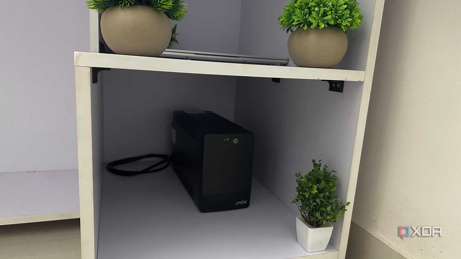 An image of a white computer table with sectioned compartments.