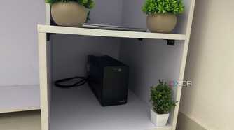An image of a white computer table with sectioned compartments.