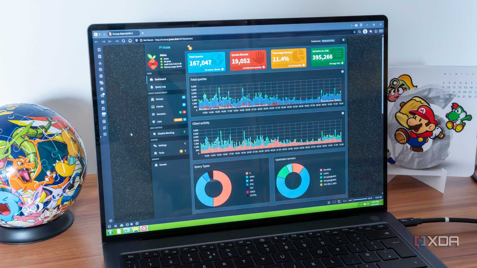 A Windows laptop showing the Pi-hole dashboard in a web browser