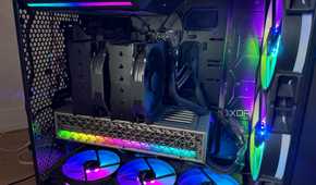 A photo of a PC build powered on with RGB lights and an air cooler