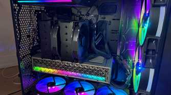 A photo of a PC build powered on with RGB lights and an air cooler
