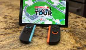A switch 2 console with joy-cons in front of it playing Welcome Tour