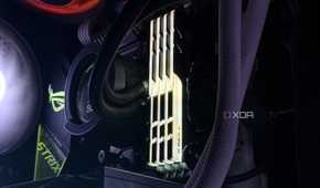 An image of an RGB DDR4 RAM kit installed on a motherboard illuminated in a yellow glow.