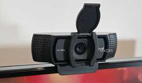 a webcam with an open privacy cover on top of a computer display