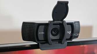 a webcam with an open privacy cover on top of a computer display