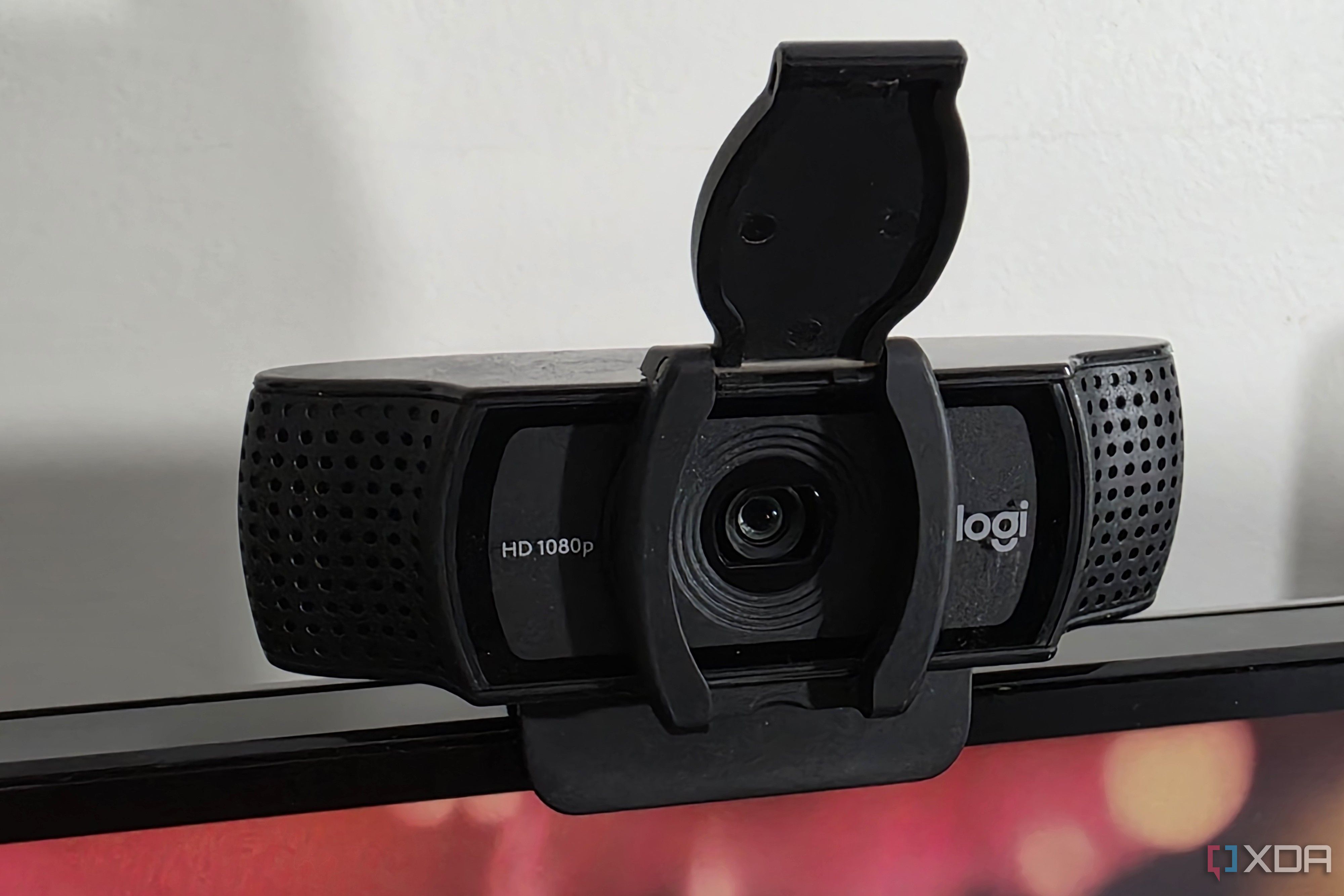 a webcam with an open privacy cover on top of a computer display