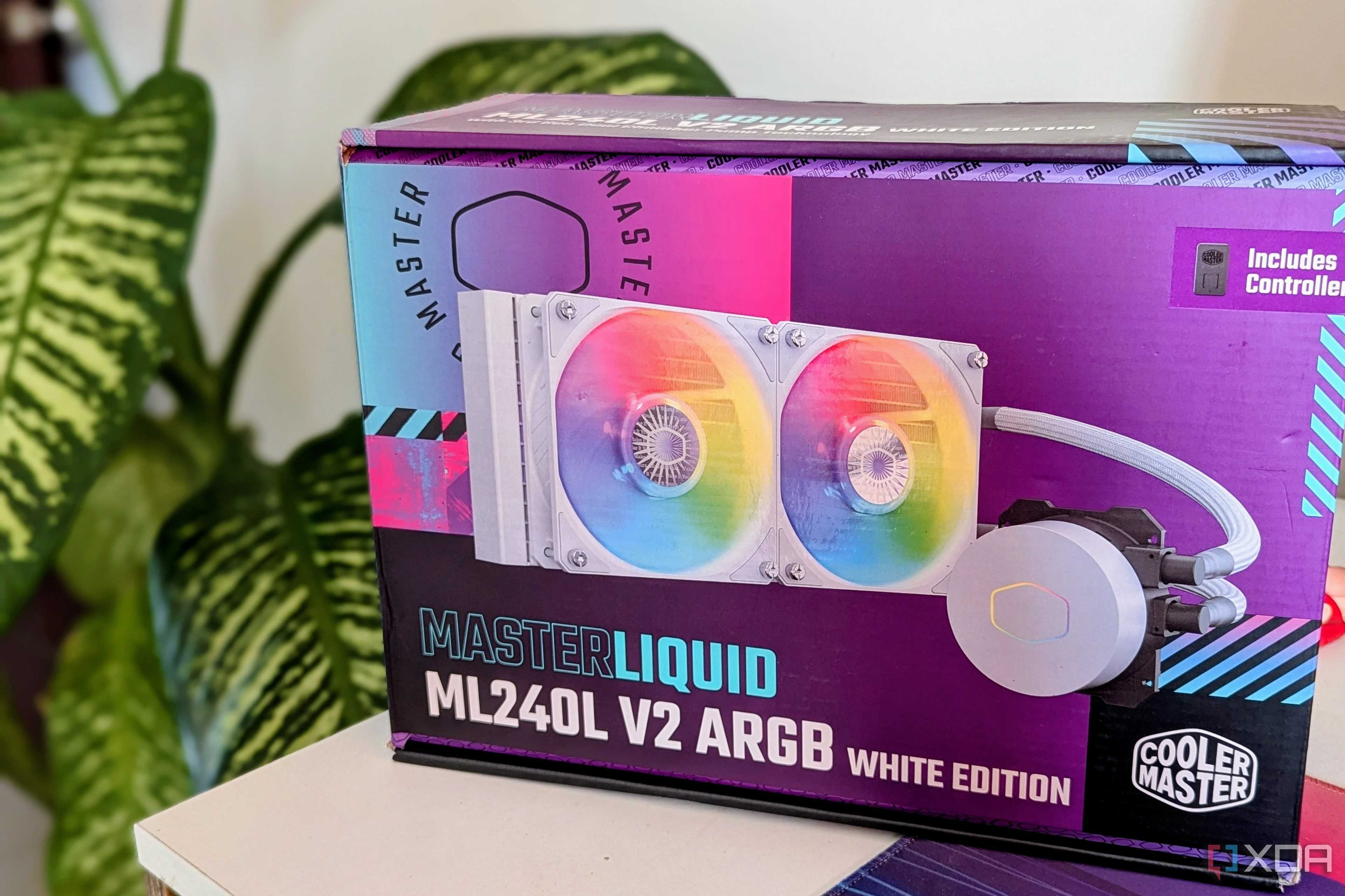 An AIO liquid cooler box on a desk next to a plant