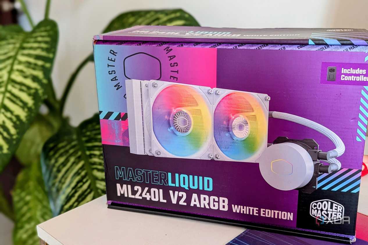 An AIO liquid cooler box on a desk next to a plant