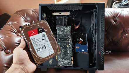 Linux has quietly change into extra forward-thinking than Home windows, and those 6 options turn out it A person holding an HDD in front of a custom-built NAS