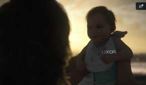 Baby Lou and Sam on the beach in Death Stranding 2.
