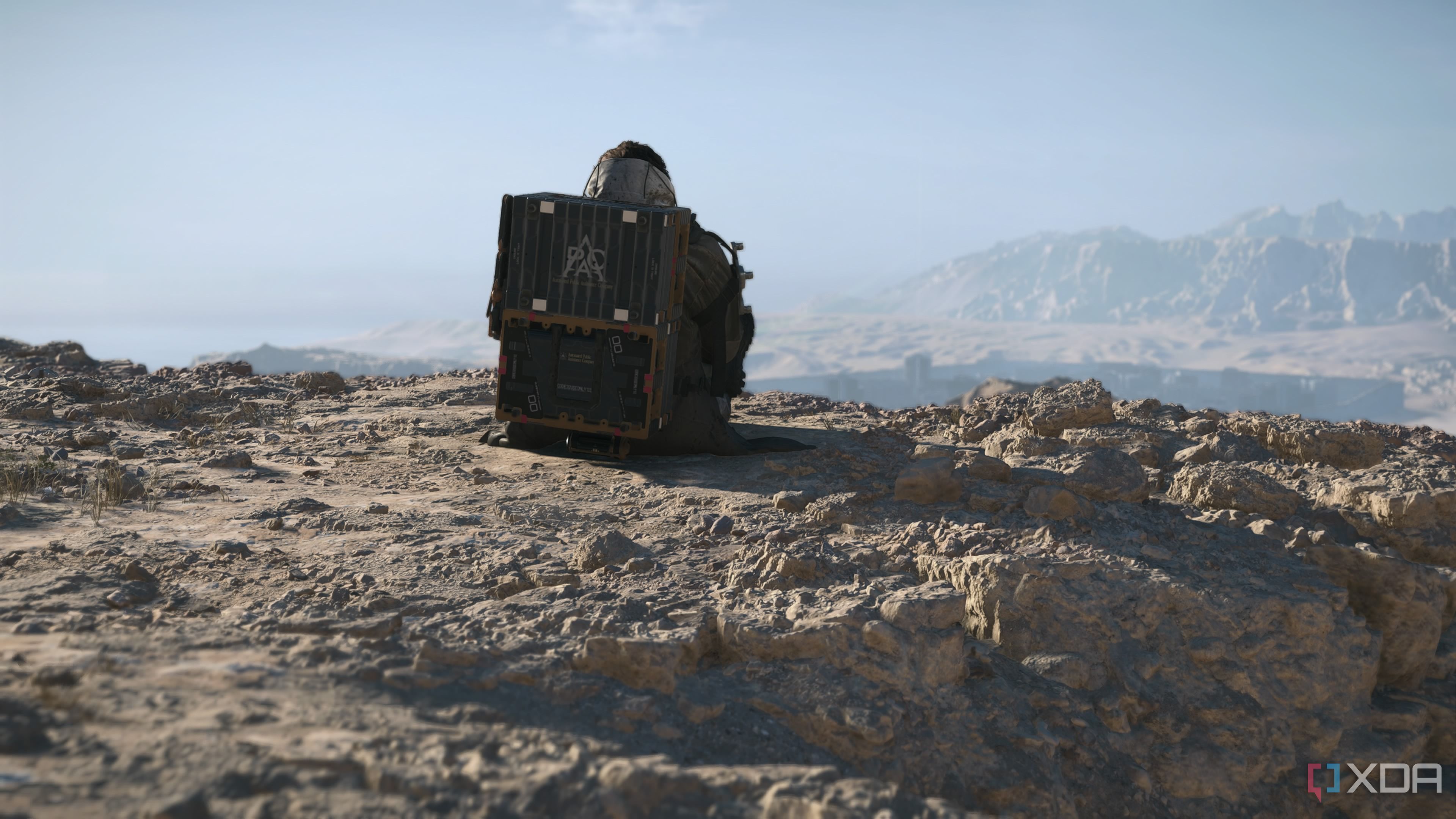 Sam seated at a cliff in Death Stranding 2.