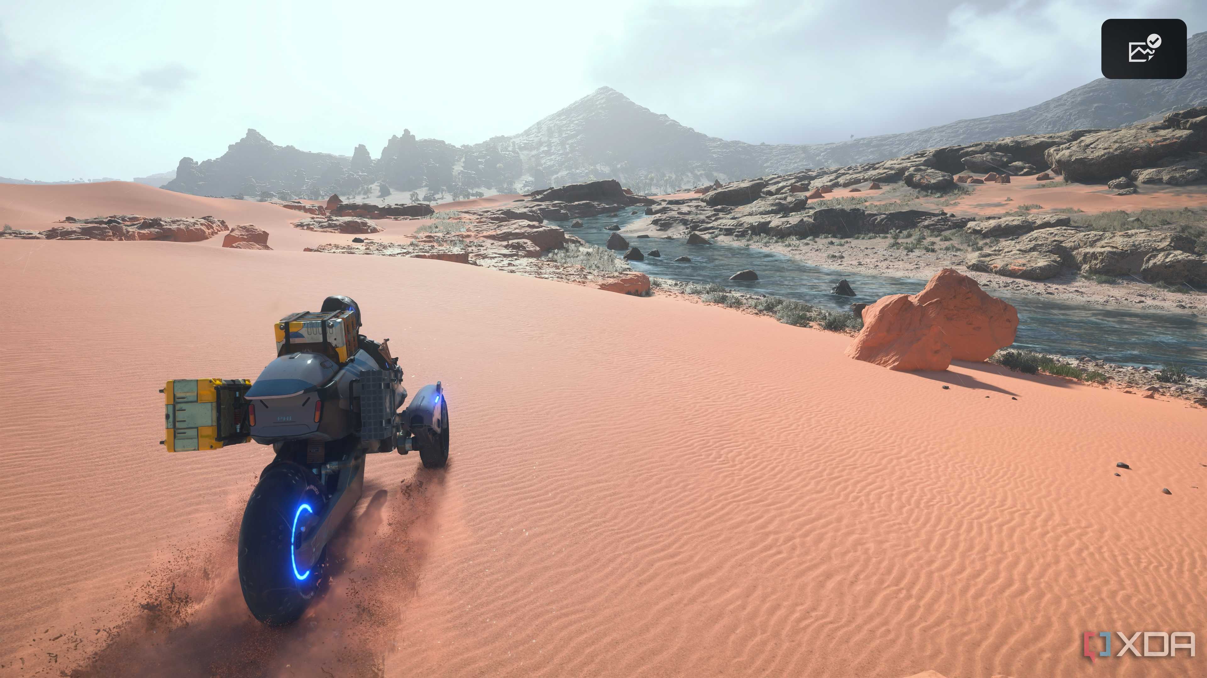 Sam driving a trike on desert sands in Death Stranding 2.