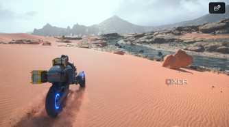 Sam driving a trike on desert sands in Death Stranding 2.