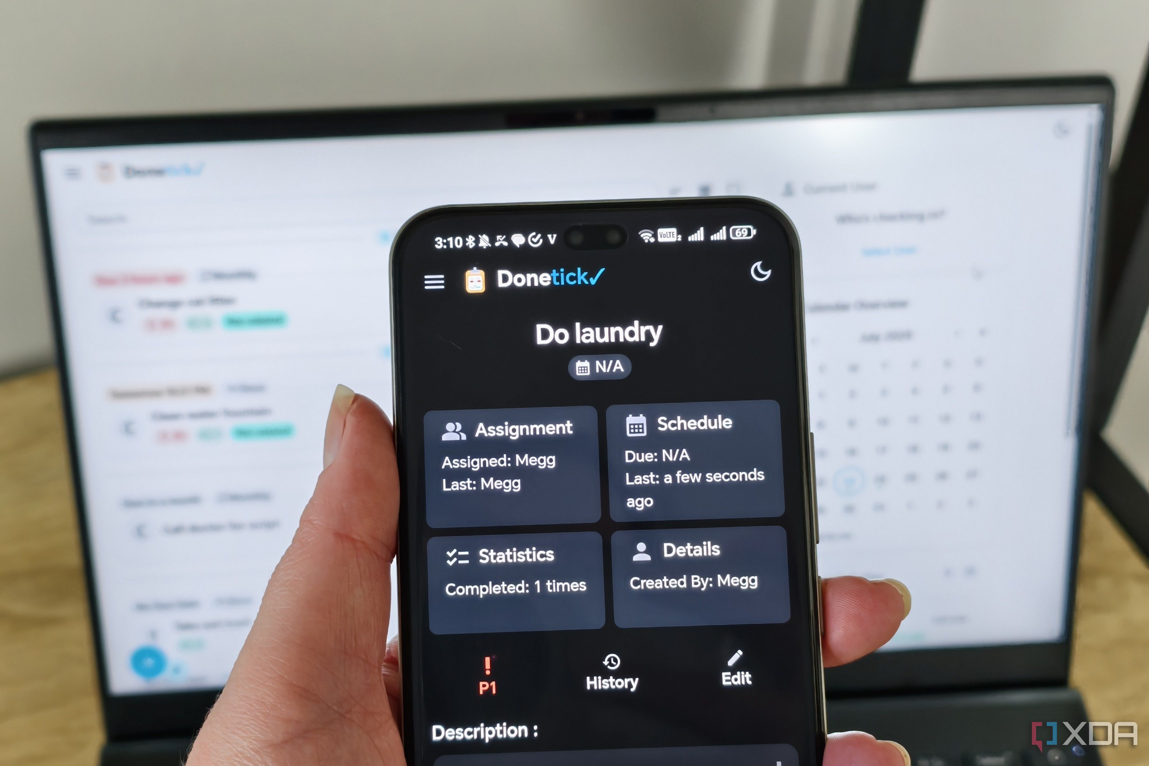donetick site on a phone with a laptop in the background