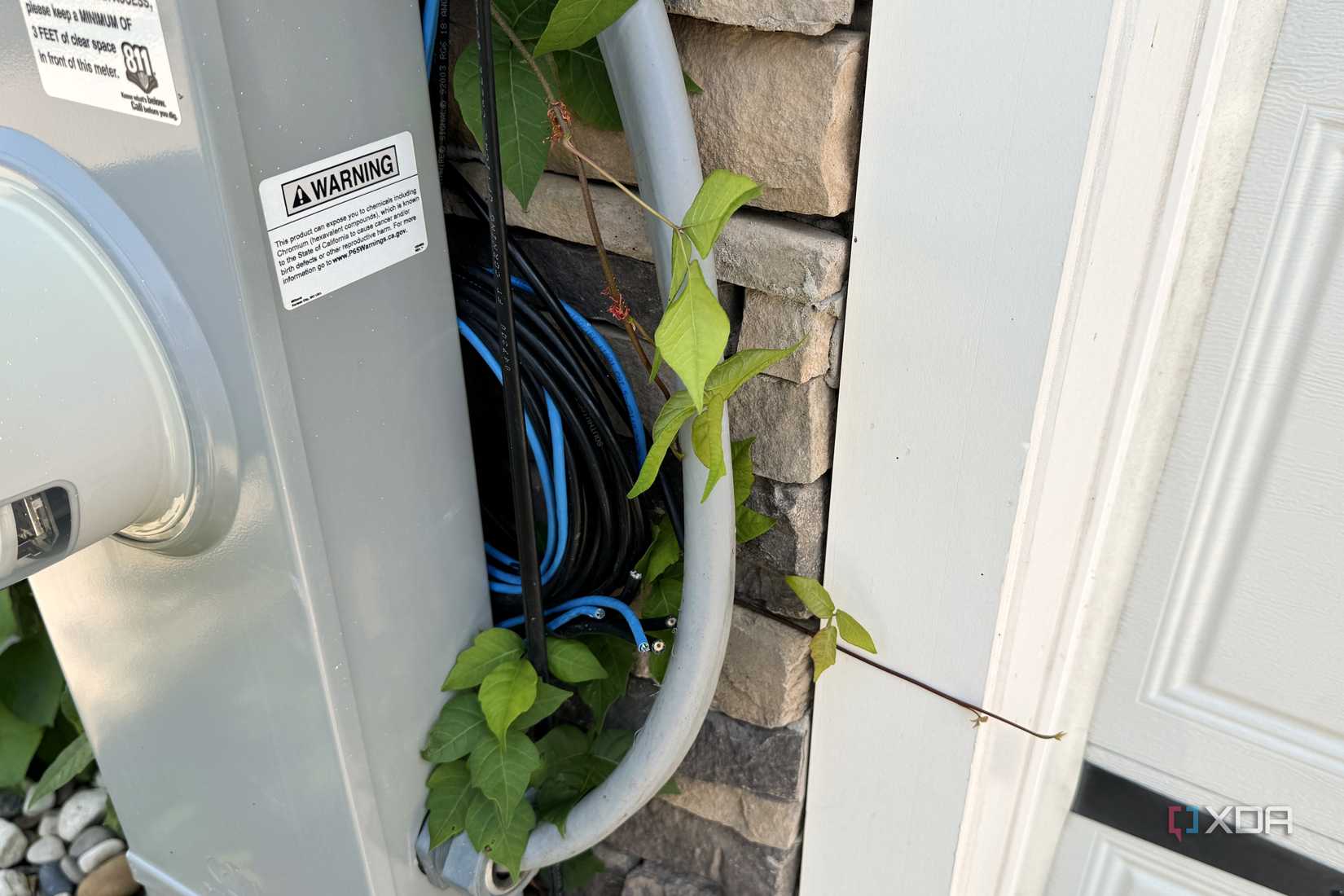 loop of cat5e and coax wiring outside garage wall