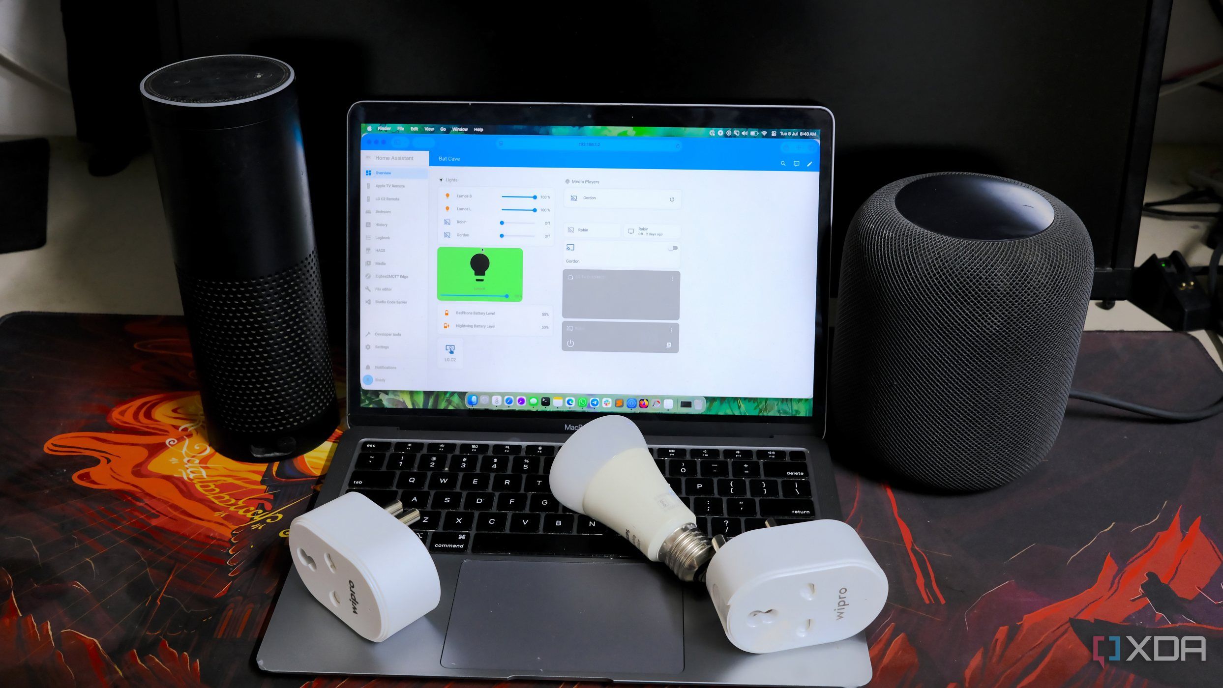 A photo of smart plugs, smart bulbs, smart speakers, and a laptop running Home Assistant