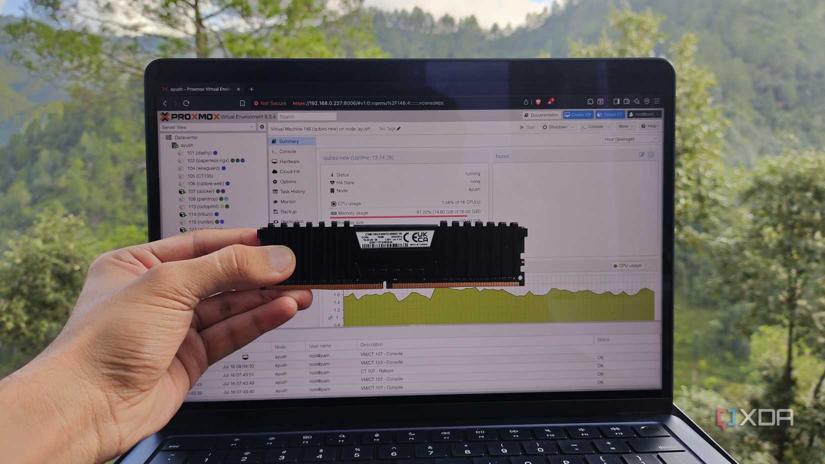 A person holding a RAM stick in front of MacBook running Proxmox