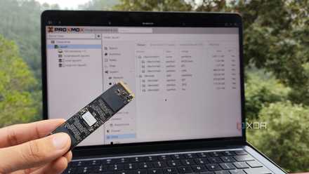 Person holding SSD in front of Proxmox web UI