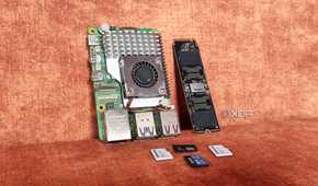 A Raspberry Pi lying next to an SSD and some microSD cards