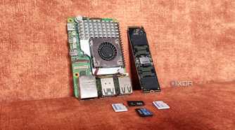A Raspberry Pi lying next to an SSD and some microSD cards