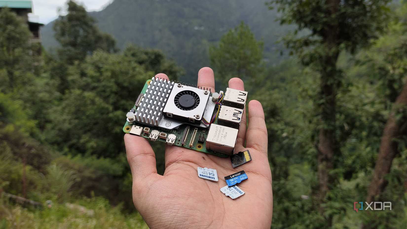 A person holding a Raspberry Pi and some microSD cards
