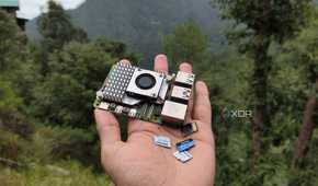 A person holding a Raspberry Pi and some microSD cards
