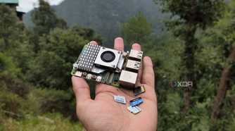 A person holding a Raspberry Pi and some microSD cards