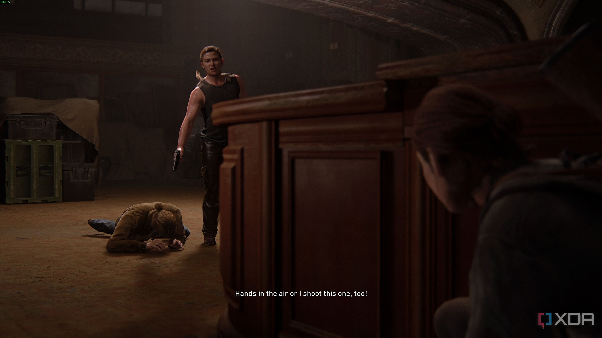 Abby holding a gun over a prone Tommy in The Last of Us Part II.