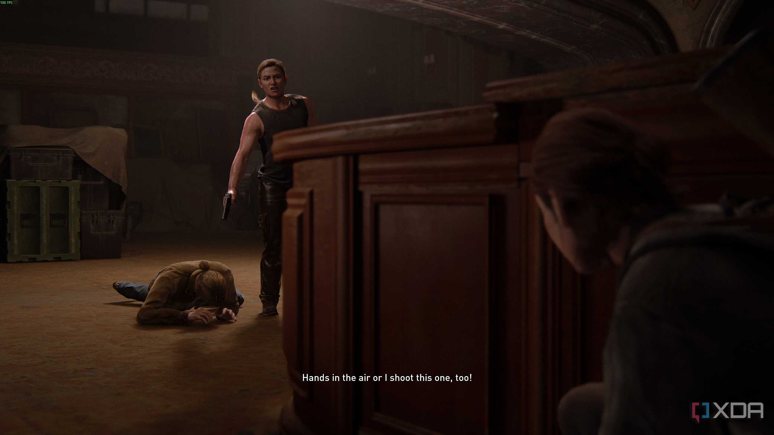 Abby holding a gun over a prone Tommy in The Last of Us Part II.