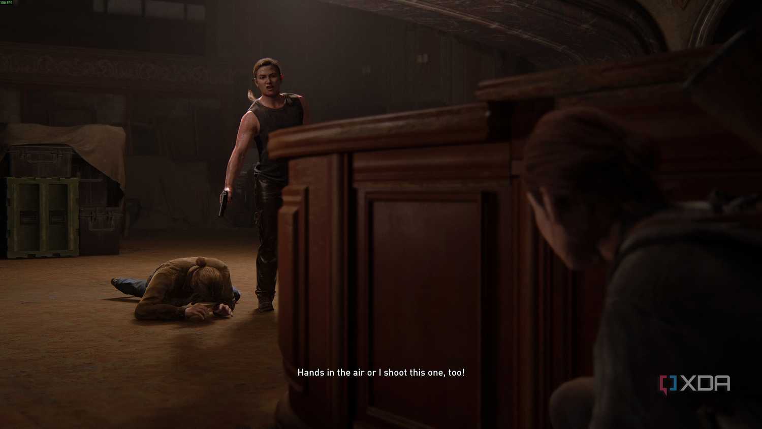 Abby holding a gun over a prone Tommy in The Last of Us Part II.