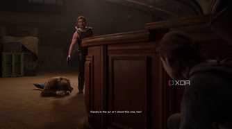 Abby holding a gun over a prone Tommy in The Last of Us Part II.