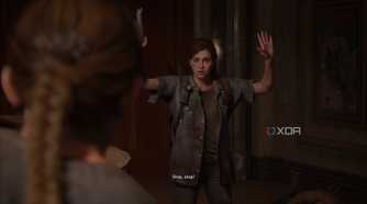 Abby holding Ellie at gunpoint in The Last of Us Part II.