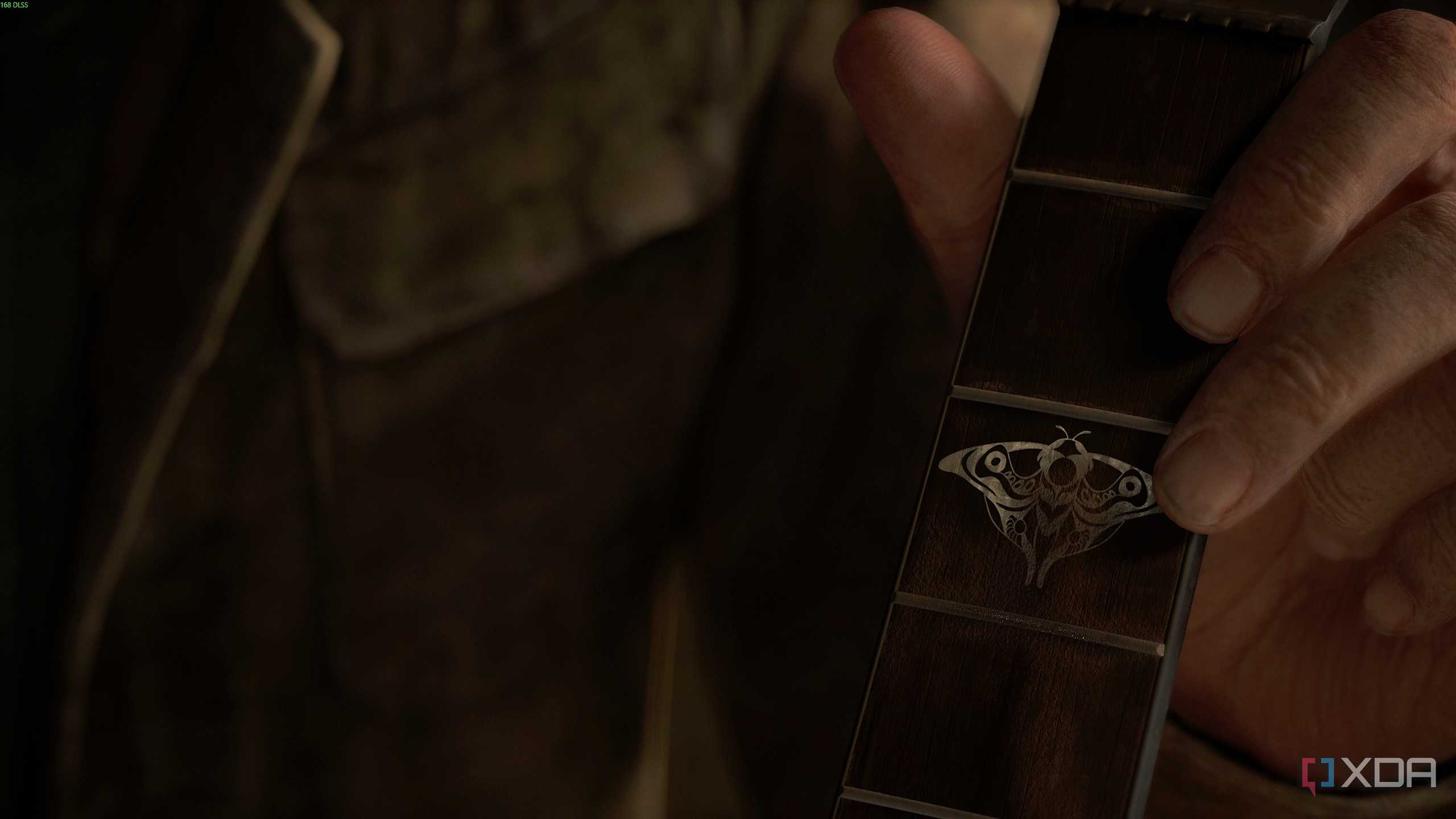 Joel holding a guitar in The Last of Us Part II.