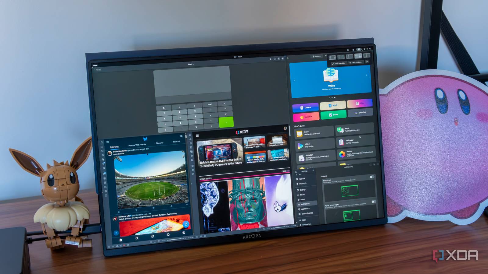 A monitor showing an Ubuntu desktop with various windows arranged using Tiling Shell
