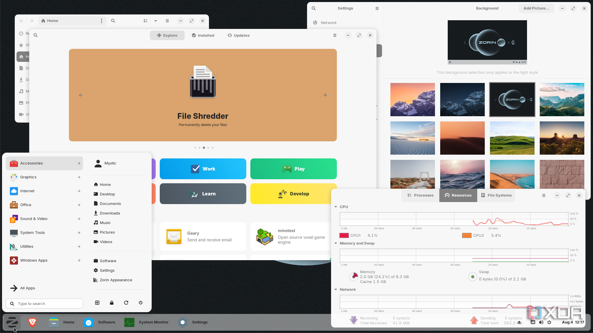 shows Zorin OS running apps and resource monitor