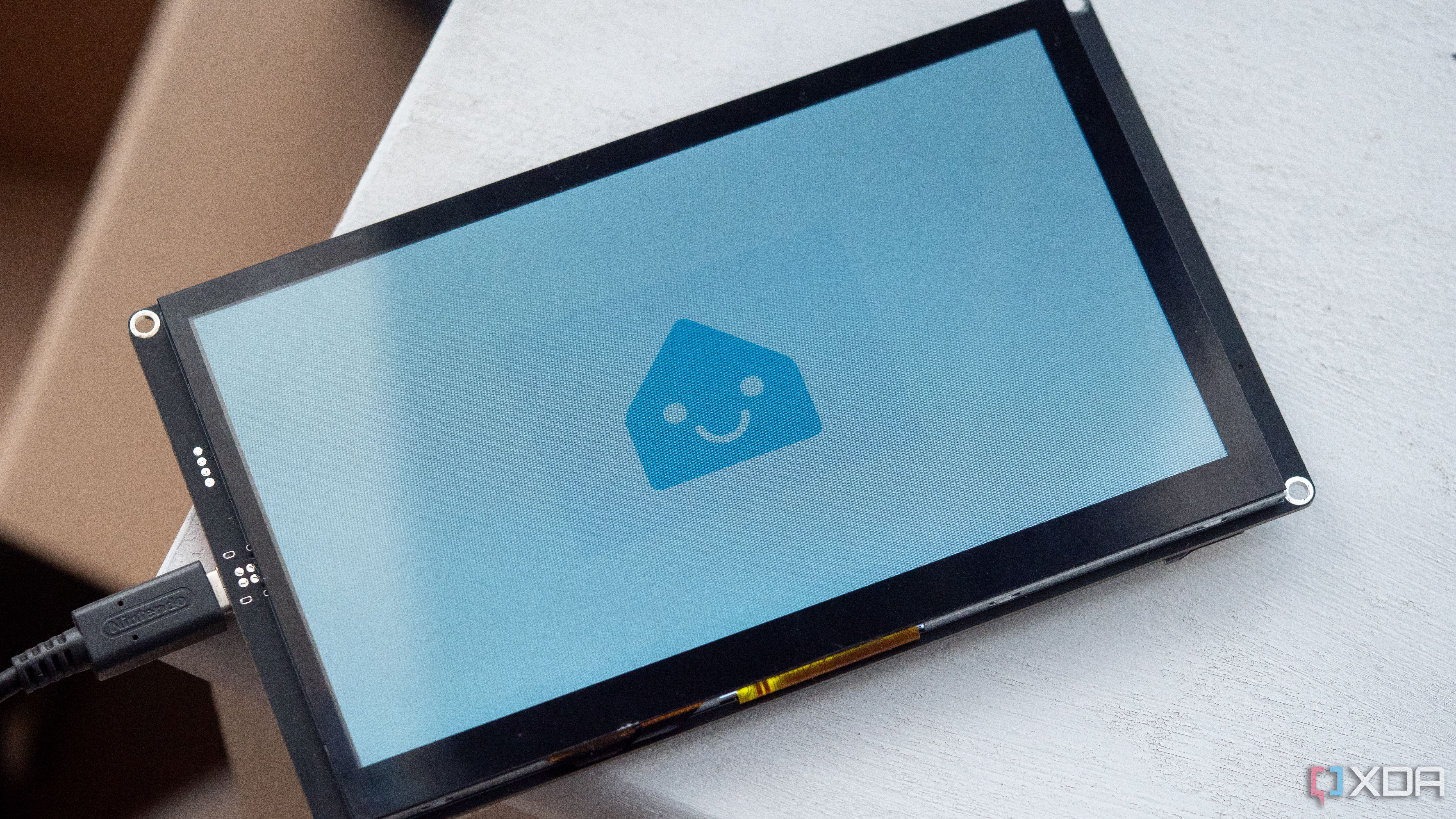 Smiling ESPHome logo on the Elecrow CrowPanel 7 inch HMI AI display with an ESP32