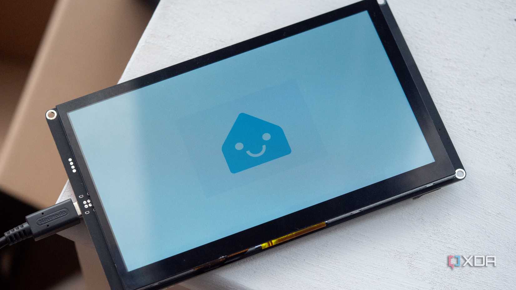 Smiling ESPHome logo on the Elecrow CrowPanel 7 inch HMI AI display with an ESP32