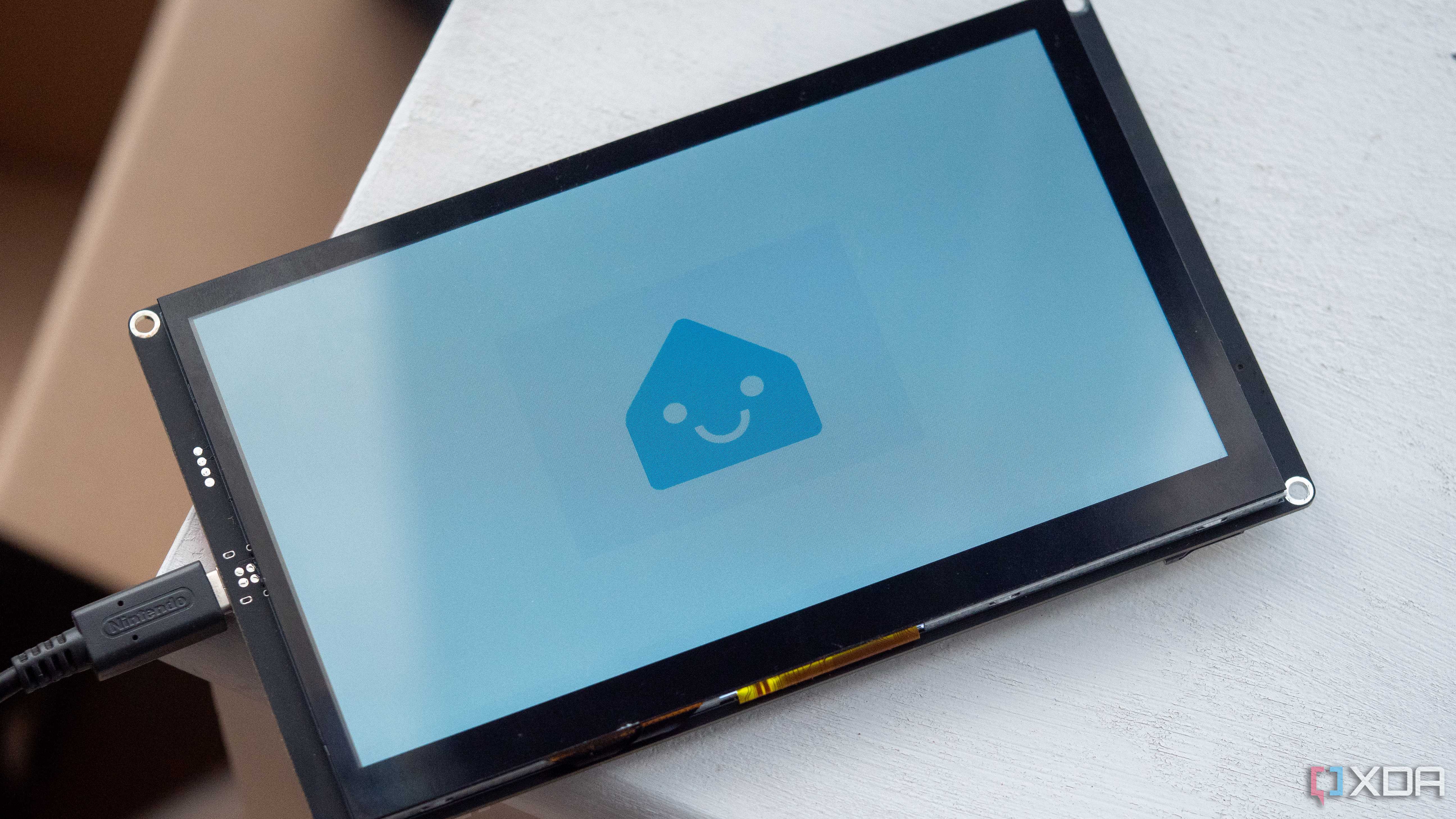 Smiling ESPHome logo on the Elecrow CrowPanel 7 inch HMI AI display with an ESP32