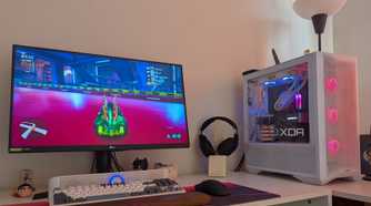 A gaming PC showing RGB lighting synced with the scene on the monitor