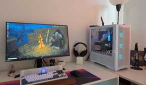 A gaming PC with blue RGB lighting next to a monitor