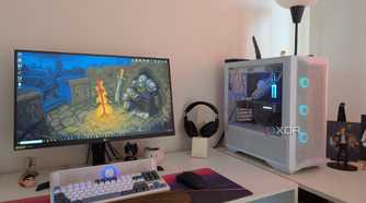 A gaming PC with blue RGB lighting next to a monitor