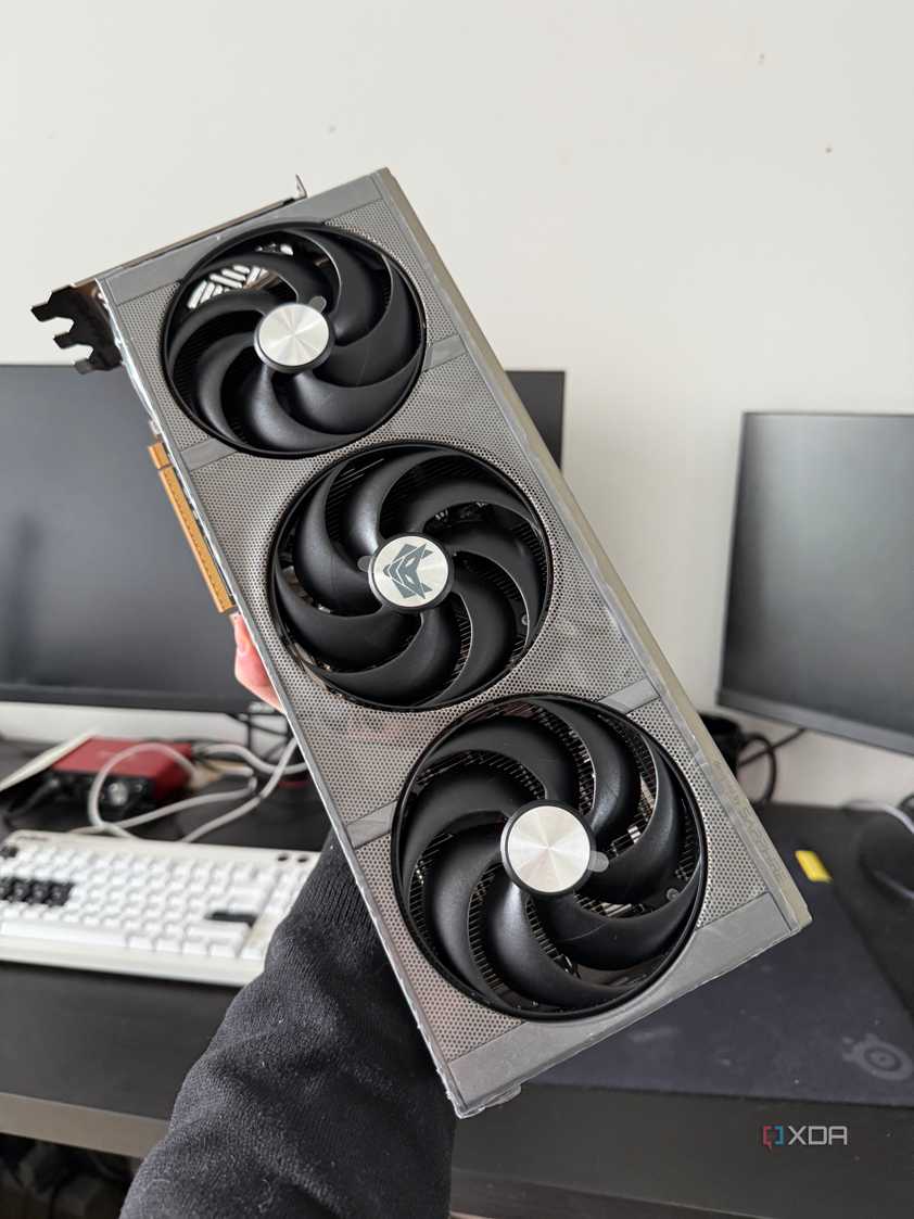 Someone holding a 9070 XT graphics card