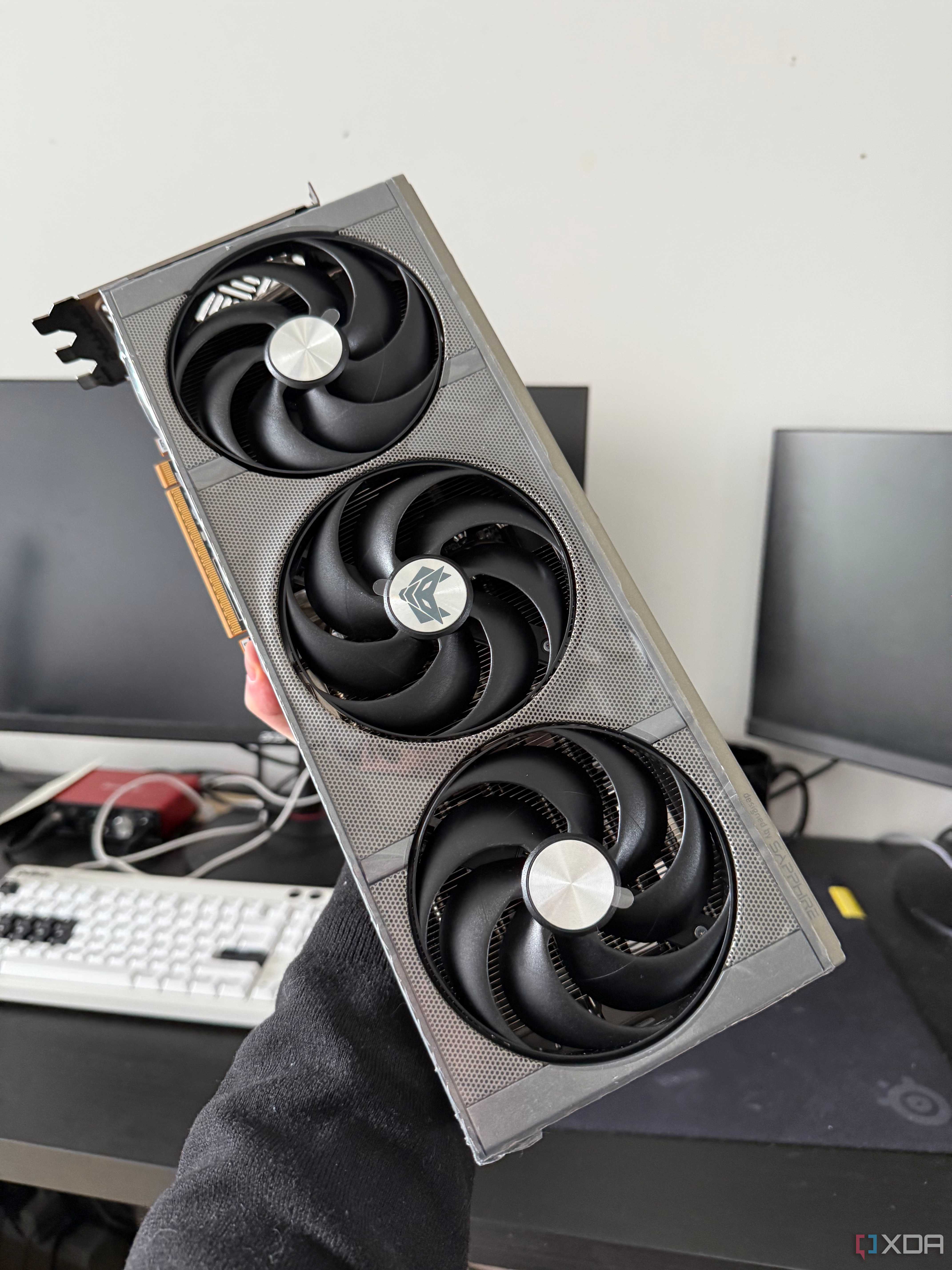 Someone holding a 9070 XT graphics card