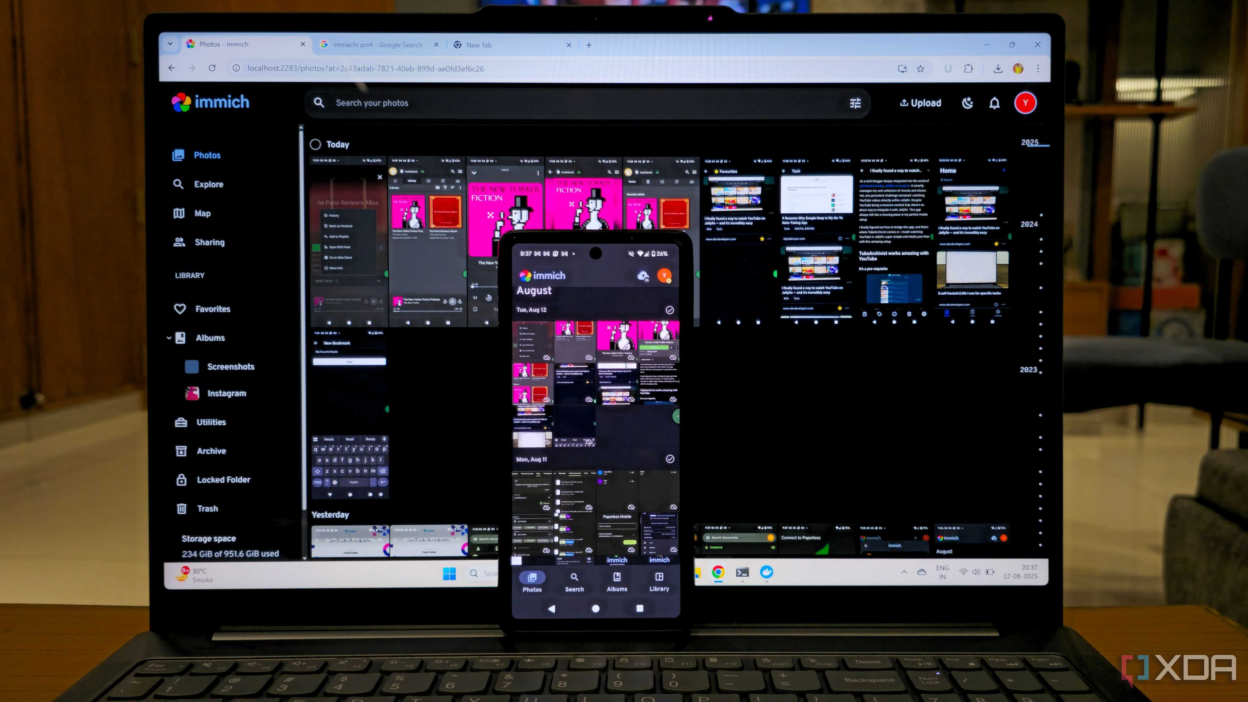 photo of Immich self-hosted platform with mobile apps on mobile and laptop