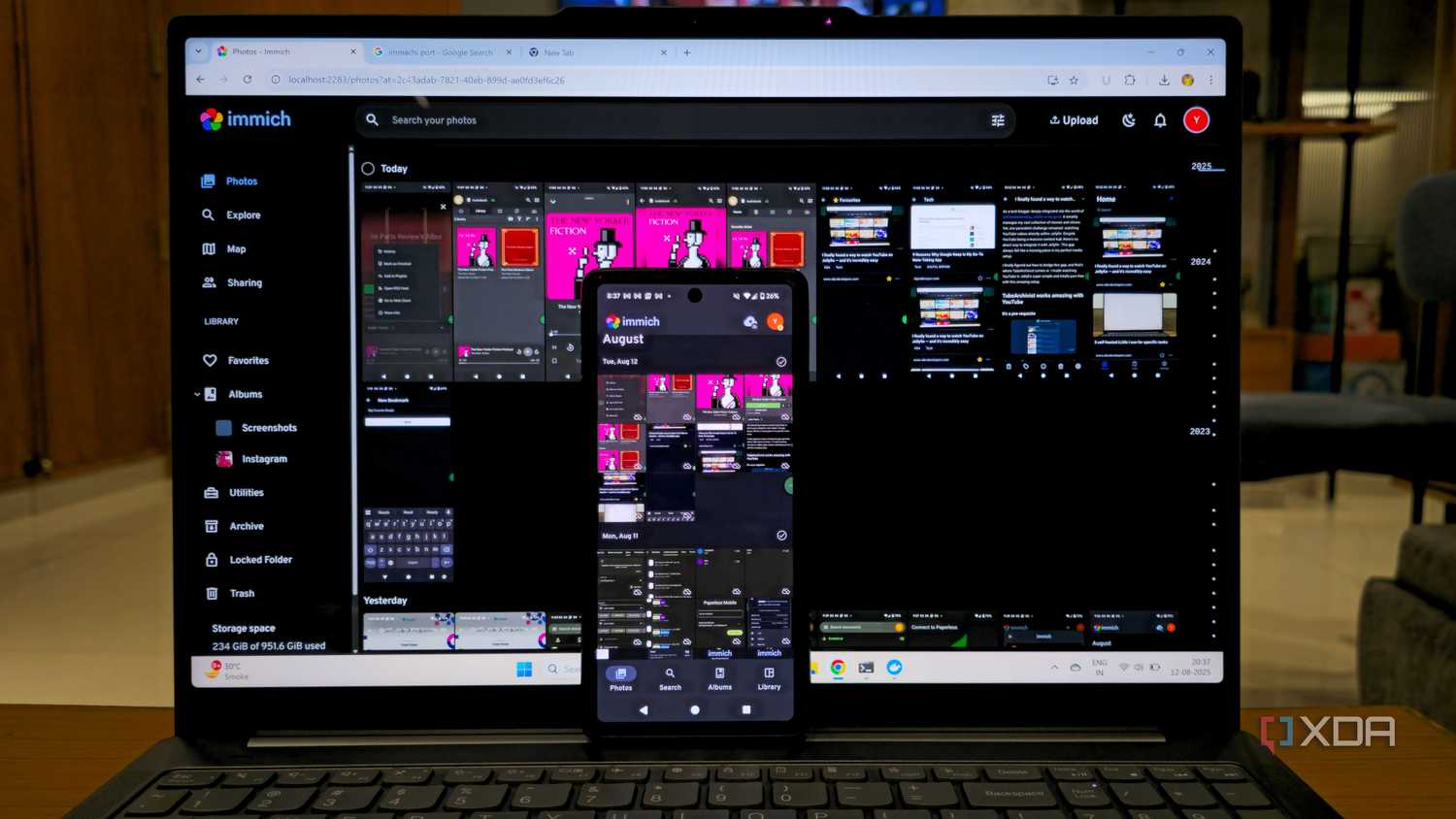 photo of Immich self-hosted platform with mobile apps on mobile and laptop