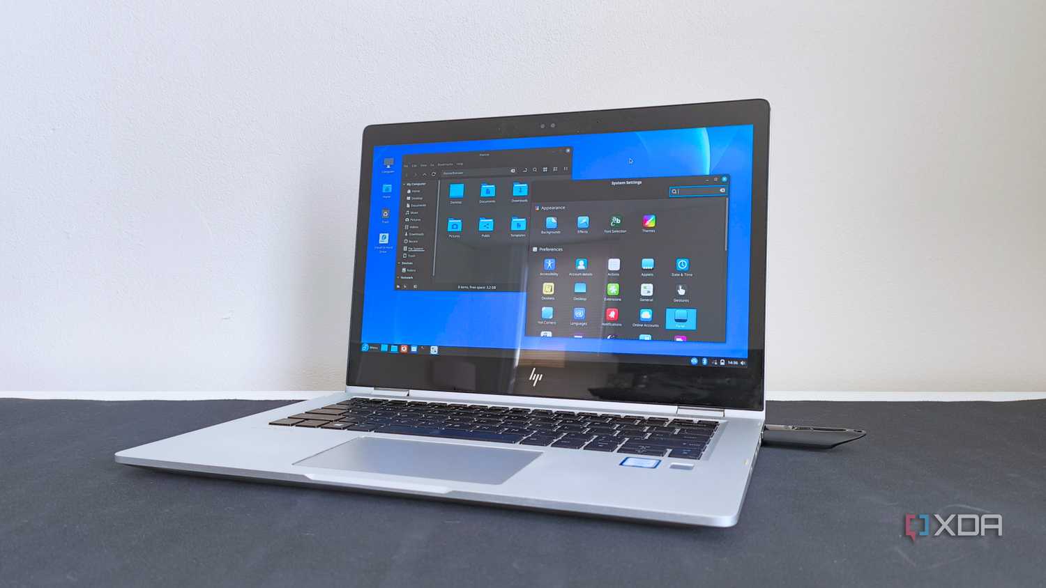 photo of a 2017 HP Elitebook x360 1030 G2 running Fedora Linux with the Cinnamon desktop environment