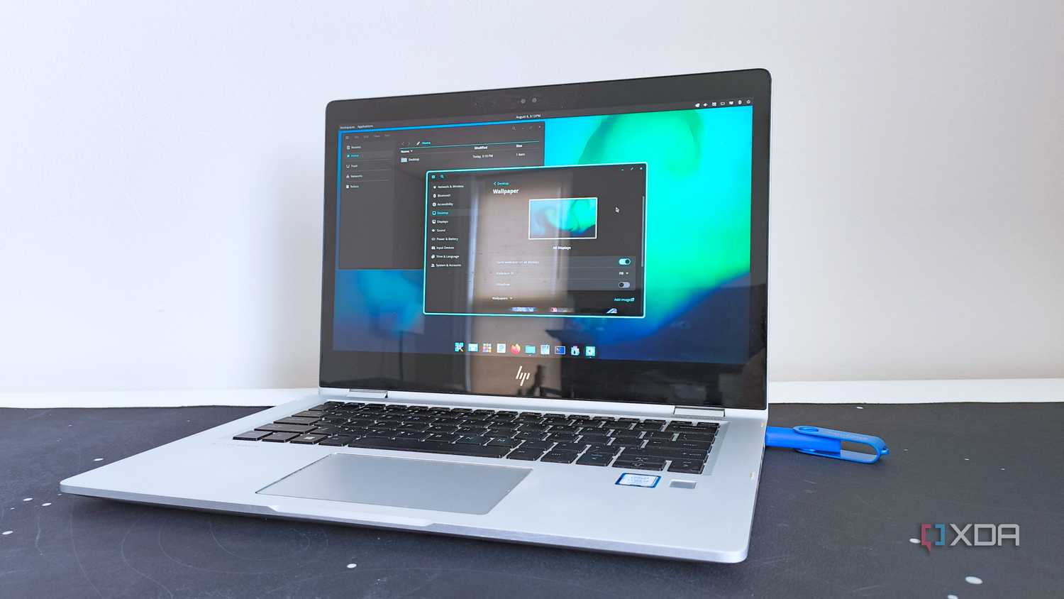 photo of a 2017 HP Elitebook x360 1030 G2 running Fedora Linux with the Cosmic desktop environment