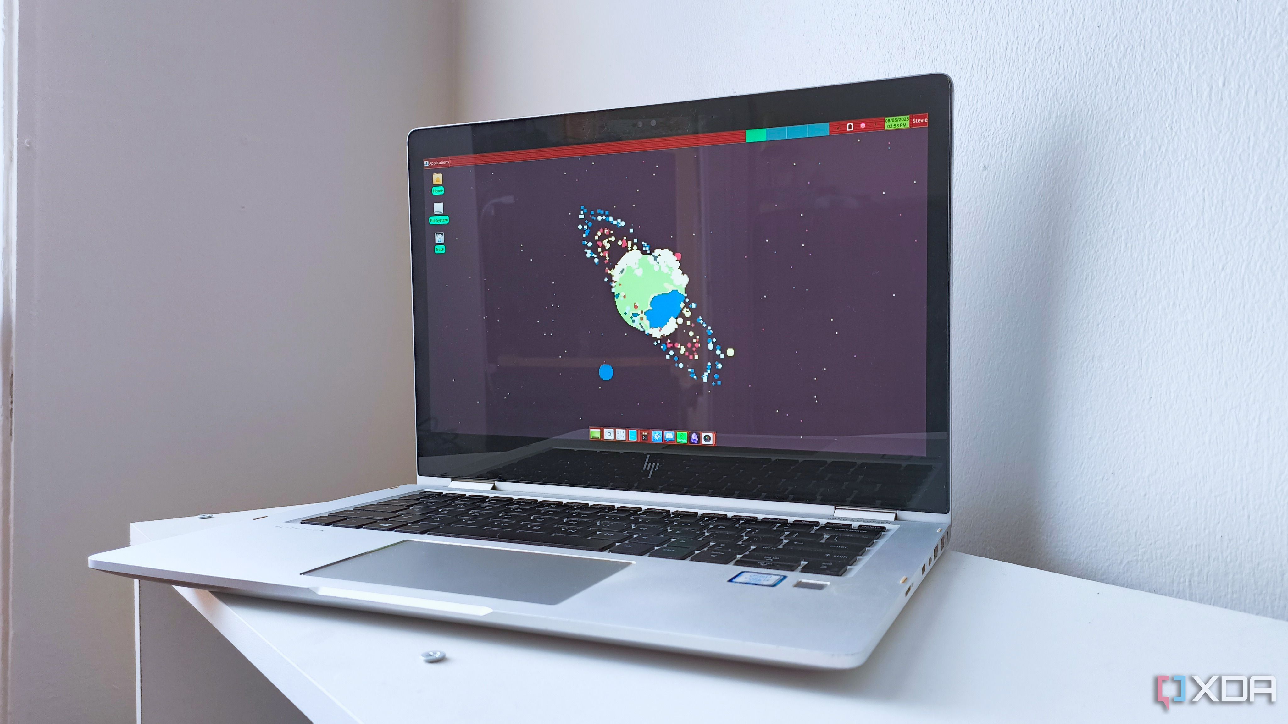 A 2017 HP EliteBook x360 1030 G2 running Fedora 42 with the XFCE desktop environment and a retro panel theme
